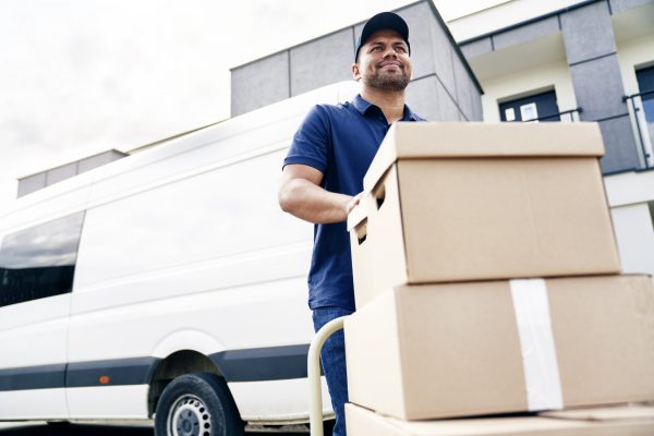 delivery-driver-moving-parcels-on-hand-truck-2021-09-03-04-15-45-utc.jpg